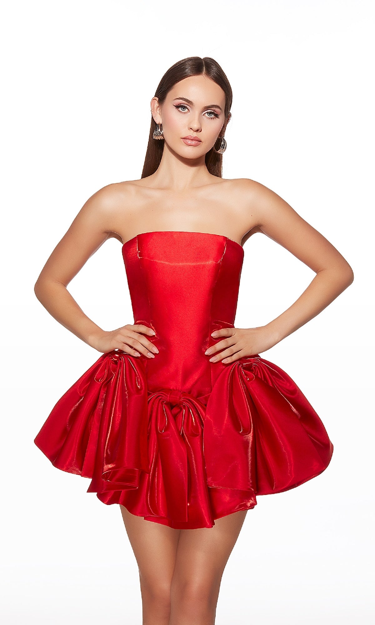 Model wearing the Alyce 30081 Short Homecoming Dress, a strapless bright red fit-and-flare style with a structured bodice and voluminous gathered skirt, posing with hands on hips against a white background.